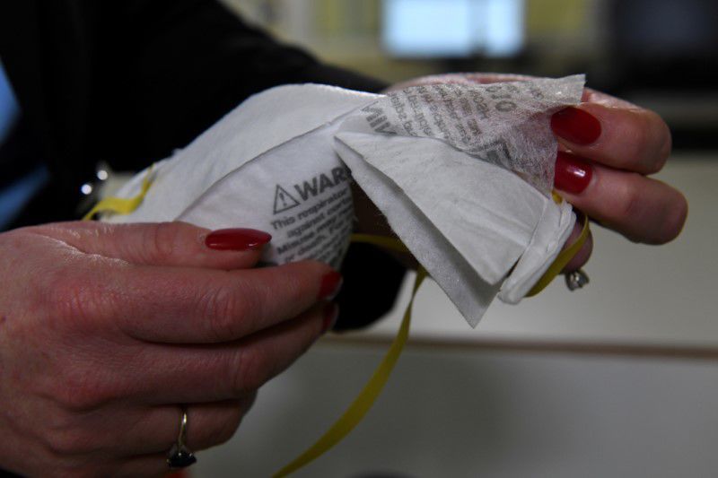 FILE PHOTO: Dr. Nicole McCullough, a global health and safety expert at 3M, reveals the various layers of a N95 respirator mask in Maplewood, Minnesota